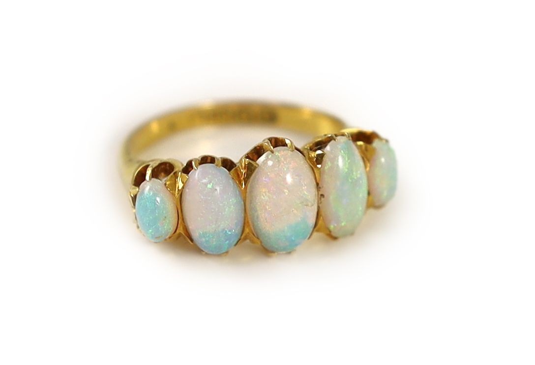 An Edwardian 18ct gold and five stone graduated white opal set half hoop ring